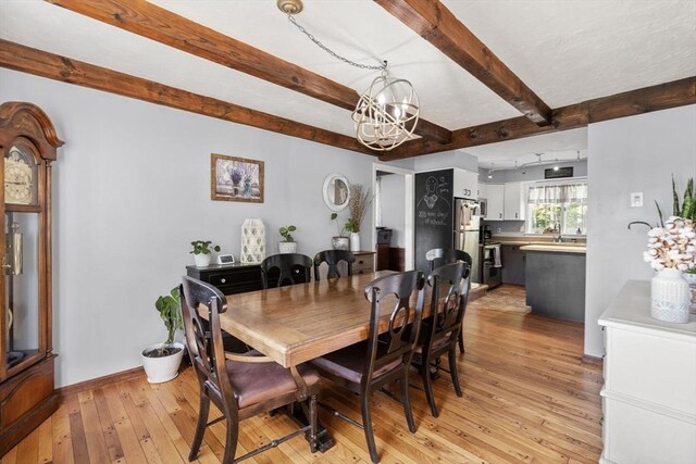 230 W St, Paxton, MA 01612 - dining area with a chandelier, beam ceiling, light wood finished floors, and baseboards