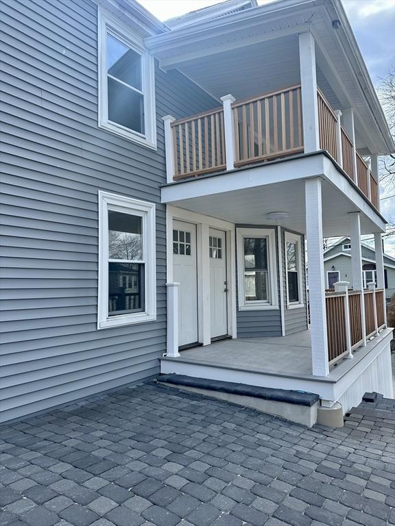 property entrance with a balcony and covered porch