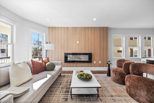 living room with hardwood / wood-style flooring and a large fireplace