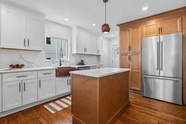 kitchen with hanging light fixtures, white cabinetry, a center island, and high quality fridge