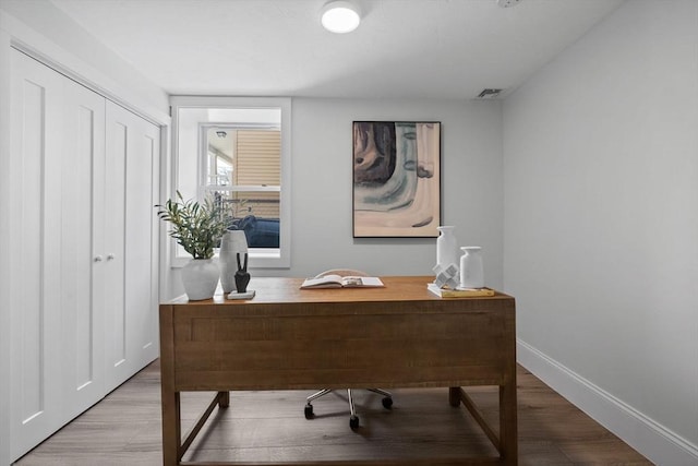 home office with hardwood / wood-style flooring