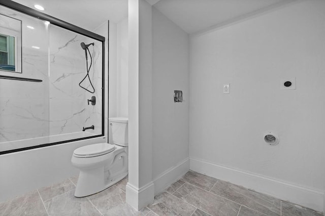 bathroom with bath / shower combo with glass door and toilet