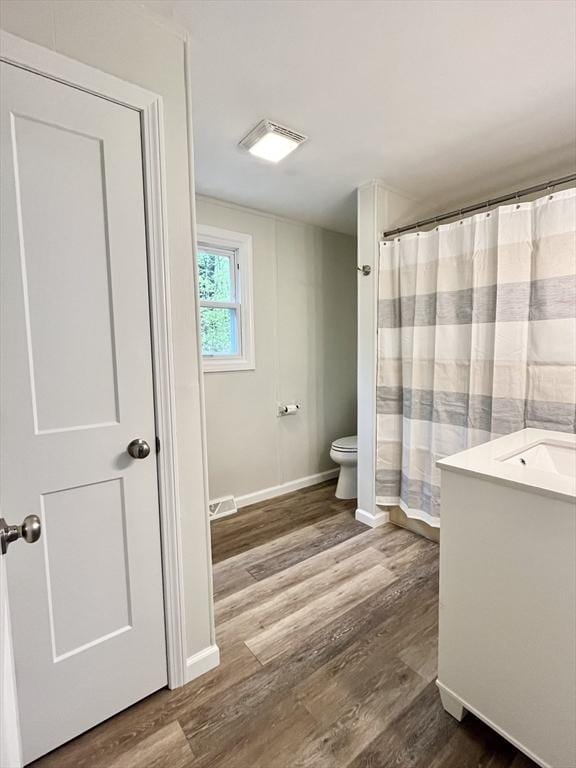 196 Munn Rd, Monson, MA 01057 - full bath featuring toilet, wood finished floors, vanity, baseboards, and curtained shower