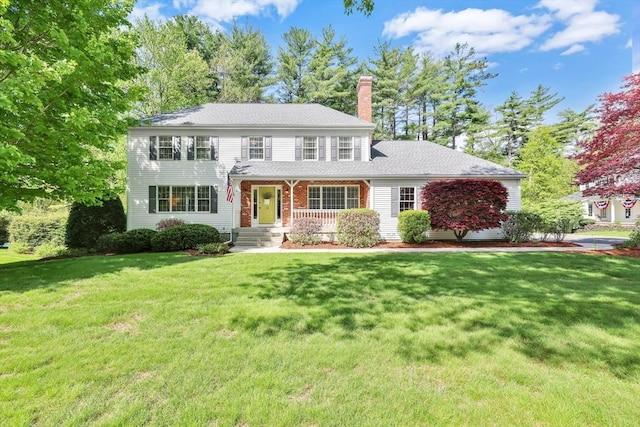 24 Heritage Cir E, Longmeadow, MA 01028 - colonial inspired home with a chimney, a front yard, and a porch