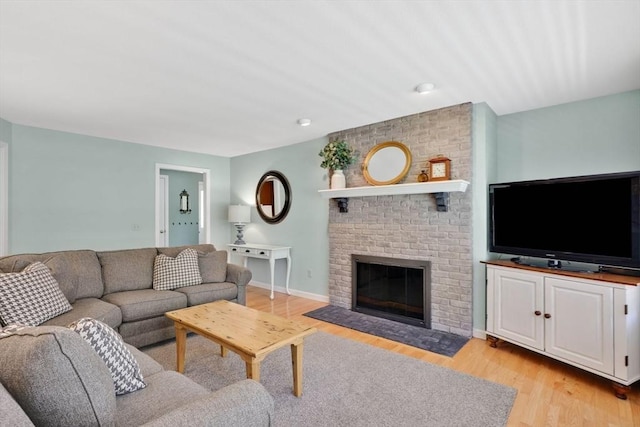 24 Heritage Cir E, Longmeadow, MA 01028 - living area featuring light wood-style flooring and a brick fireplace