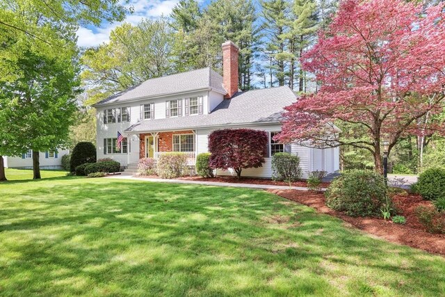24 Heritage Cir E, Longmeadow, MA 01028 - colonial house featuring a chimney, a front yard, and roof with shingles