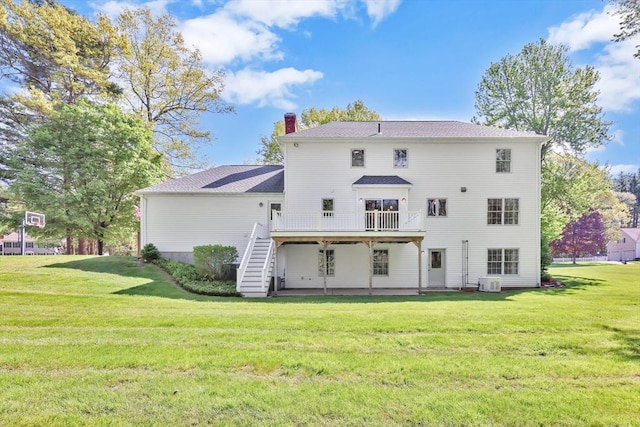 24 Heritage Cir E, Longmeadow, MA 01028 - rear view of house with a deck, a chimney, a yard, and stairway