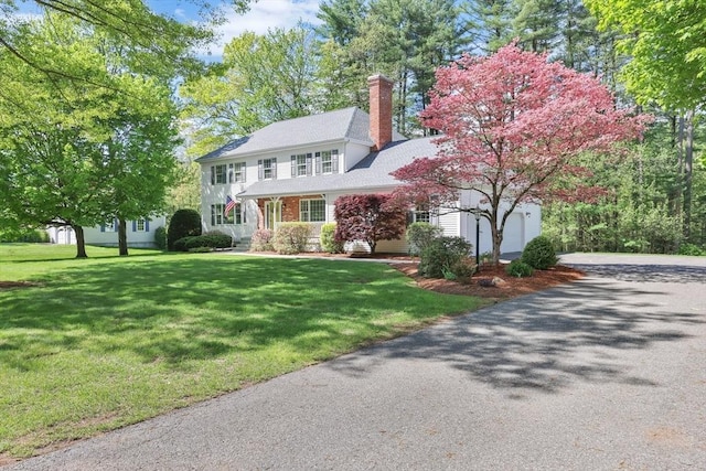 24 Heritage Cir E, Longmeadow, MA 01028 - colonial inspired home featuring driveway, a garage, a chimney, and a front lawn