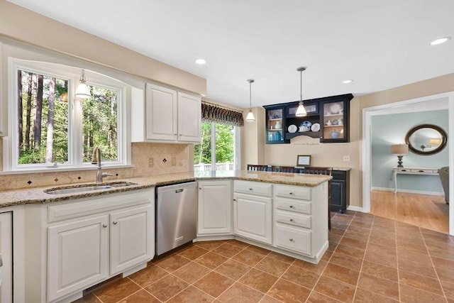 24 Heritage Cir E, Longmeadow, MA 01028 - kitchen featuring dishwasher, a sink, a peninsula, white cabinets, and tasteful backsplash