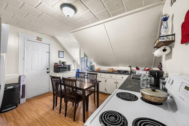 81-83 Walnut St, Lynn, MA 01905 - kitchen featuring light wood-style floors, dark countertops, white electric range, and white cabinetry