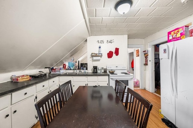 81-83 Walnut St, Lynn, MA 01905 - kitchen with white appliances, white cabinetry, light wood-style flooring, and dark countertops