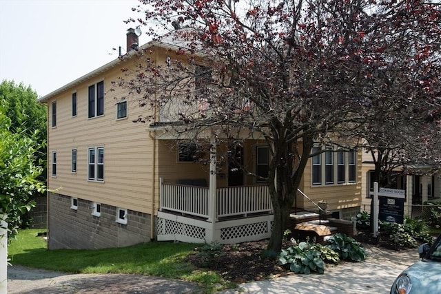 105 Fletcher St Unit 1, Boston, MA 02131 - back of house with a chimney and covered porch