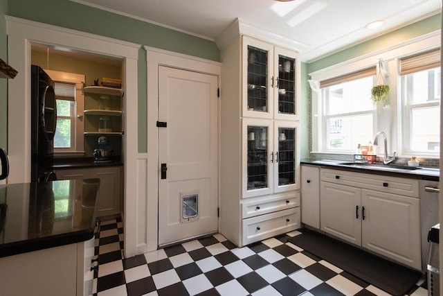 105 Fletcher St Unit 1, Boston, MA 02131 - kitchen featuring dark floors, dark countertops, white cabinets, fridge, and glass insert cabinets