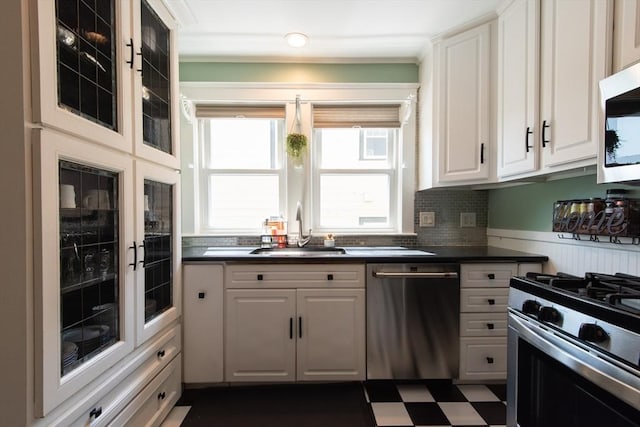 105 Fletcher St Unit 1, Boston, MA 02131 - kitchen with appliances with stainless steel finishes, dark countertops, white cabinets, dark flooring, and glass insert cabinets