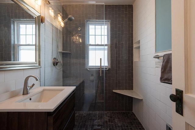 105 Fletcher St Unit 1, Boston, MA 02131 - bathroom featuring tile walls, tiled shower, vanity, and healthy amount of natural light