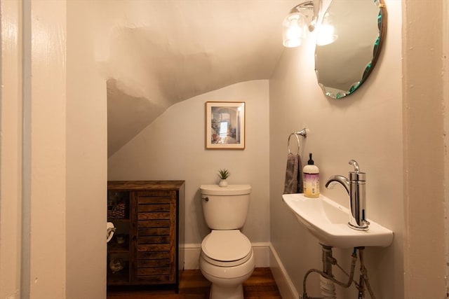 105 Fletcher St Unit 1, Boston, MA 02131 - half bathroom featuring lofted ceiling and wood finished floors