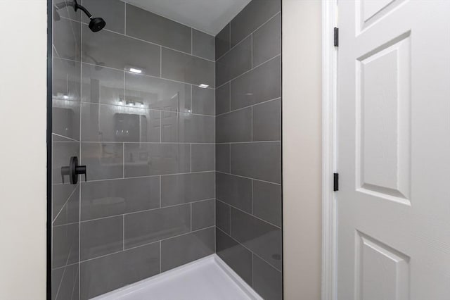 full bath with a tile shower