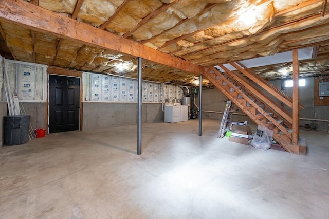 unfinished basement featuring stairs, electric panel, and washer / clothes dryer