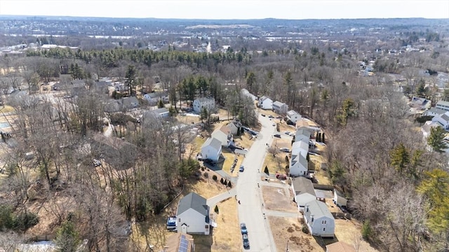 drone / aerial view featuring a forest view and a residential view