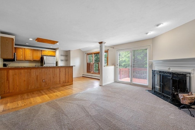 14 Midgley Ln, Worcester, MA 01604 - unfurnished living room with a baseboard heating unit, light colored carpet, ornate columns, a fireplace with flush hearth, and recessed lighting
