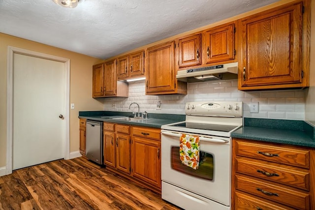 kitchen featuring brown cabinets, under cabinet range hood, dishwasher, a sink, and white range with electric cooktop