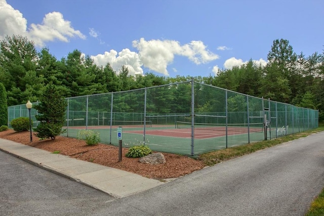view of sport court featuring fence
