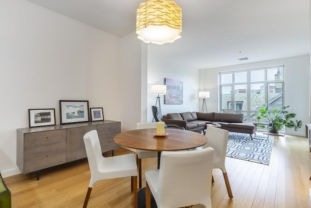 dining space featuring light wood-style floors