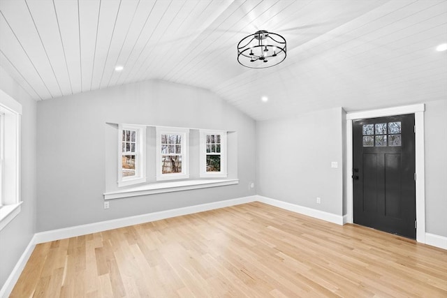 entrance foyer with a chandelier, light hardwood / wood-style floors, lofted ceiling, and wood ceiling