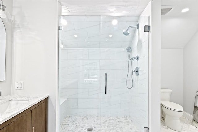 bathroom featuring an enclosed shower, vanity, and toilet