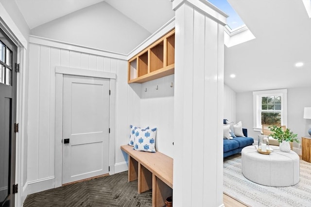 mudroom featuring vaulted ceiling with skylight and parquet floors