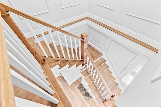 stairway featuring hardwood / wood-style floors