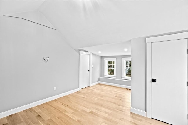 bonus room with light hardwood / wood-style flooring and lofted ceiling