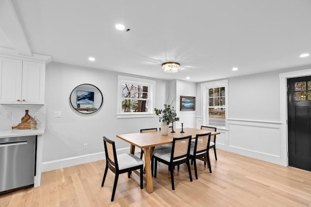 dining area with a chandelier, light wood-type flooring, and plenty of natural light