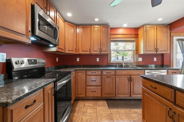 40 George St, Attleboro, MA 02703 - kitchen with stainless steel appliances, a sink, light tile patterned flooring, brown cabinetry, and recessed lighting