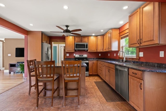 40 George St, Attleboro, MA 02703 - kitchen with appliances with stainless steel finishes, a sink, recessed lighting, a breakfast bar, and a ceiling fan