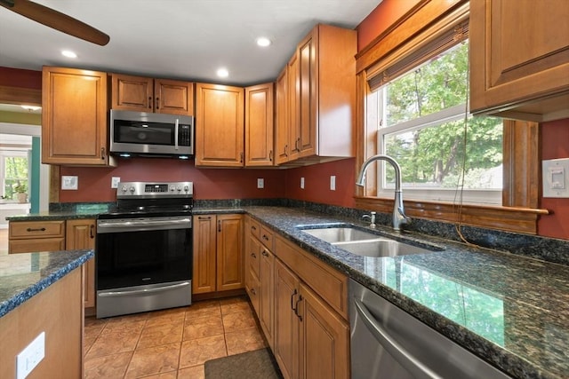 40 George St, Attleboro, MA 02703 - kitchen featuring appliances with stainless steel finishes, a sink, dark stone countertops, recessed lighting, and brown cabinetry