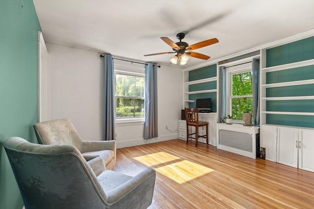 40 George St, Attleboro, MA 02703 - living area featuring wood finished floors, a ceiling fan, radiator, and plenty of natural light