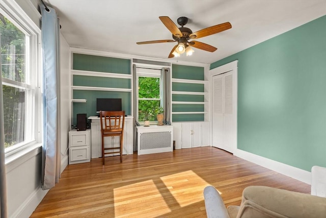 40 George St, Attleboro, MA 02703 - interior space featuring radiator, wood finished floors, a ceiling fan, and baseboards