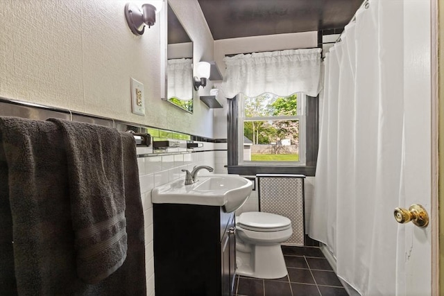 40 George St, Attleboro, MA 02703 - full bath with tile patterned floors, toilet, vanity, a textured wall, and tile walls