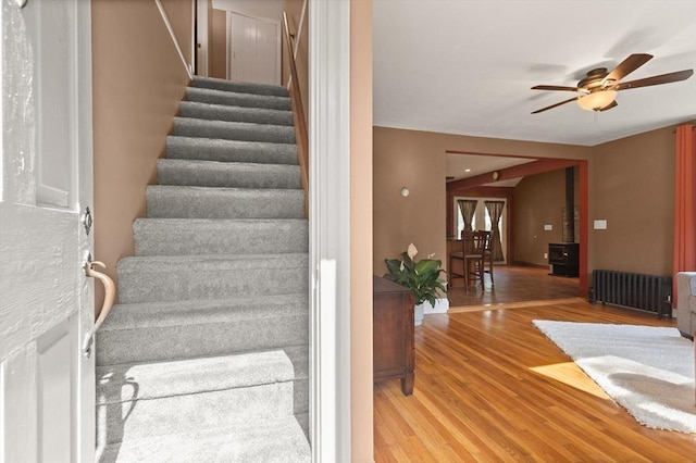 40 George St, Attleboro, MA 02703 - staircase featuring radiator heating unit, a ceiling fan, and wood finished floors