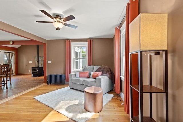 40 George St, Attleboro, MA 02703 - living area featuring radiator, light wood finished floors, a ceiling fan, and baseboards