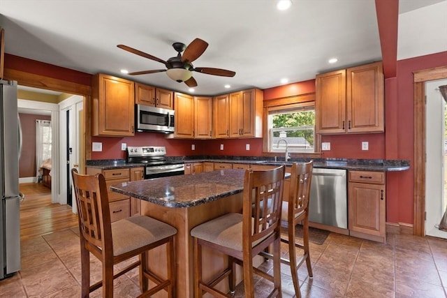 40 George St, Attleboro, MA 02703 - kitchen with stainless steel appliances, a sink, a breakfast bar, a ceiling fan, and recessed lighting