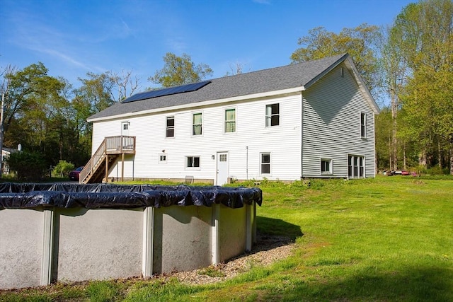 76 Kennedy Rd, West Brookfield, MA 01585 - back of property featuring solar panels, a yard, a covered pool, stairway, and a wooden deck