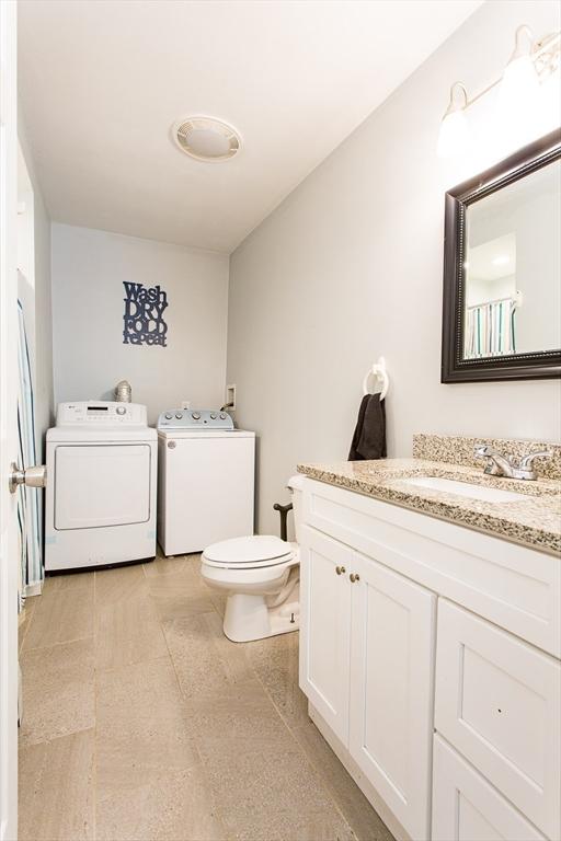 76 Kennedy Rd, West Brookfield, MA 01585 - bathroom featuring washer and dryer, toilet, and vanity