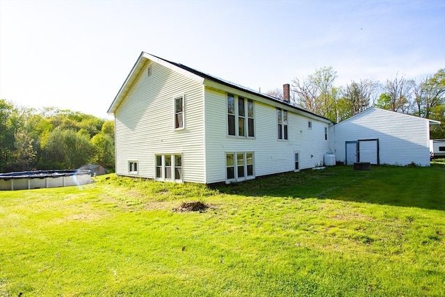 76 Kennedy Rd, West Brookfield, MA 01585 - rear view of house featuring a yard, a covered pool, and a chimney