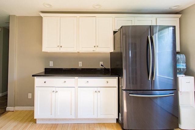 76 Kennedy Rd, West Brookfield, MA 01585 - kitchen featuring freestanding refrigerator, light wood-style floors, white cabinets, baseboards, and dark stone countertops