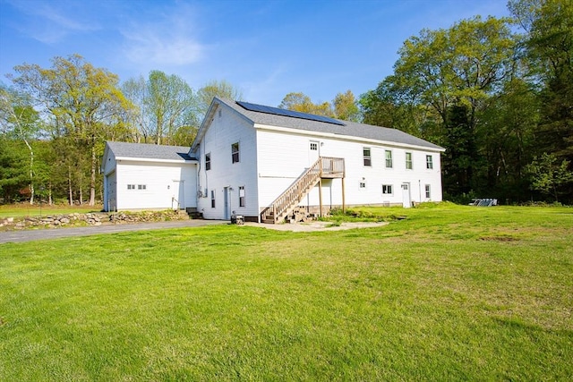 76 Kennedy Rd, West Brookfield, MA 01585 - rear view of property with solar panels, a lawn, and stairway