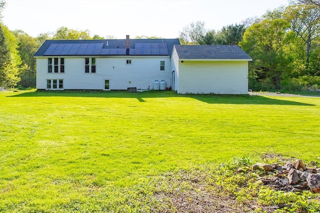 76 Kennedy Rd, West Brookfield, MA 01585 - rear view of house featuring a yard, solar panels, and a chimney