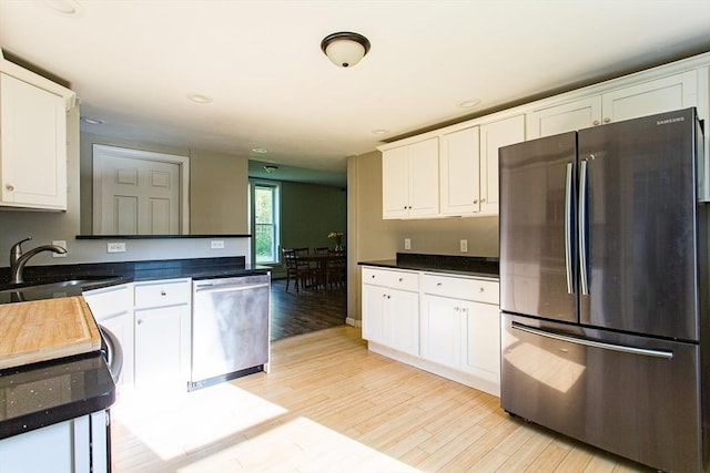 76 Kennedy Rd, West Brookfield, MA 01585 - kitchen featuring appliances with stainless steel finishes, a sink, white cabinetry, light wood-style flooring, and recessed lighting