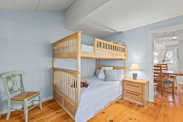 bedroom with lofted ceiling and light hardwood / wood-style flooring